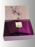 Plum and berry-toned hijabs Plum and berry-toned hijabs are displayed in a lavender floral gift box with a soft ivory and gold flower brooch. in a lavender floral gift box with a soft ivory and gold flower brooch.