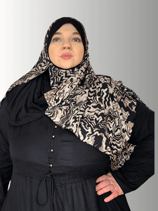 Animal print scarf with earthy tone and a bold black solid contrast color ,sophisticated muslim woman 