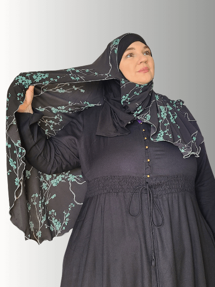 A serene handmade hijab with delicate teal floral vines on a navy background, exuding elegance and comfort. Made from premium jersey fabric, ideal for both casual and formal wear.
