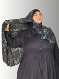 A serene handmade hijab with delicate teal floral vines on a navy background, exuding elegance and comfort. Made from premium jersey fabric, ideal for both casual and formal wear.
