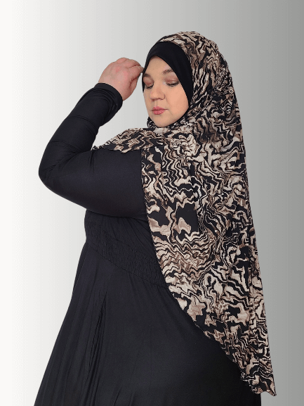 Animal print scarf with earthy tone and a bold black solid contrast color ,sophisticated muslim woman 