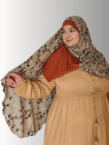 Amber Serenity Hijab from the Luxe Harmony Collection, showcasing a luxurious blend of soft amber hues on premium chiffon. Designed with a comfortable jersey base for easy wear, this elegant hijab drapes beautifully, making it ideal for both casual and formal occasions."
