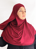 Deep burgundy red double loop instant hijab with attached undercap, styled on a mannequin to highlight its flow and elegant color depth.