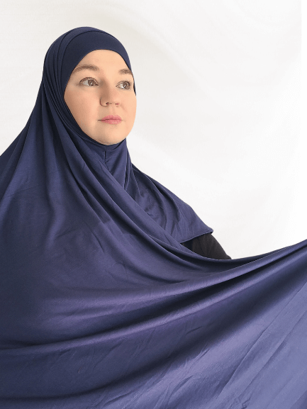 Deep navy blue instant jersey hijab named Indigo Mist, with a slight sapphire undertone and matching undercap, styled on neutral background.
