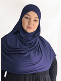 Deep navy blue double loop hijab with a built-in undercap, shown in natural light highlighting its rich color and soft, thick texture.
