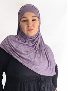 Muted dusty lavender instant jersey hijab named Lavender Fog, soft lightweight material, paired with matching undercap on neutral background.

