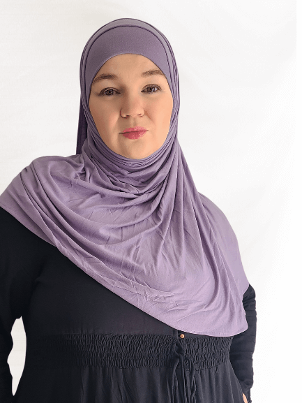 Muted dusty lavender instant jersey hijab named Lavender Fog, soft lightweight material, paired with matching undercap on neutral background.
