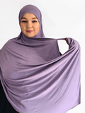 Light lavender-grey double loop instant hijab with attached undercap, draped softly on a mannequin showing its smooth texture and graceful flow.
