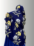 A stylish instant double-loop hijab named Midnight Garden Veil, featuring a navy blue base with floral patterns in white, yellow, and sage green tones, designed for effortless styling and all-day comfort.
