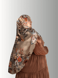 Blossom Whisper Veil, an elegant hijab from the Luxe Harmony Collection, featuring earthy cream tones with delicate pink and white floral accents, crafted with a chiffon overlay and jersey base for instant, effortless styling.
