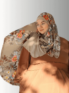 Blossom Whisper Veil, an elegant hijab from the Luxe Harmony Collection, featuring earthy cream tones with delicate pink and white floral accents, crafted with a chiffon overlay and jersey base for instant, effortless styling."
