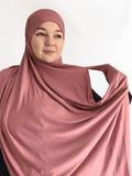 Soft rose-mauve double loop jersey hijab with attached undercap, styled in romantic, flowy layers for an elegant everyday finish.
