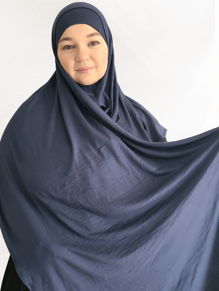 A cool-toned navy-teal Instant Jersey Shawl with a smooth finish and elegant structure, paired with a matching undercap.
