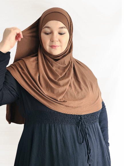 Dark mocha brown instant jersey hijab shawl with a slightly thicker fabric and matching undercap, styled in a soft, neutral setting.