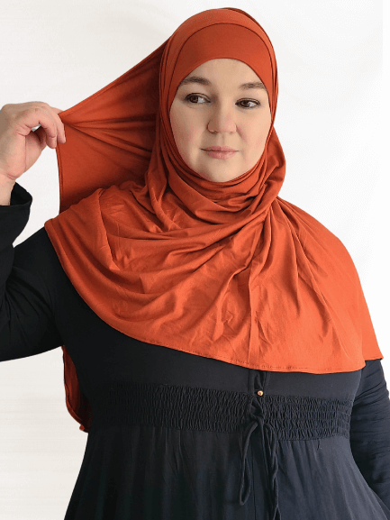 Vivid burnt orange Instant Jersey Shawl in a rich sienna shade, styled with a matching undercap, perfect for year-round wear.
