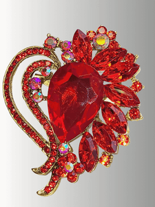 Gold brooch with a red teardrop gemstone and surrounding red rhinestones.