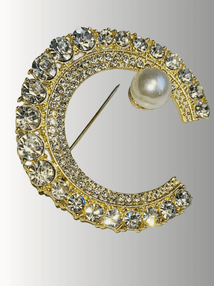 Gold crescent hijab brooch with clear rhinestones and pearl detail.