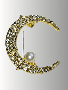 Gold crescent moon brooch with rhinestones and a pearl accent.